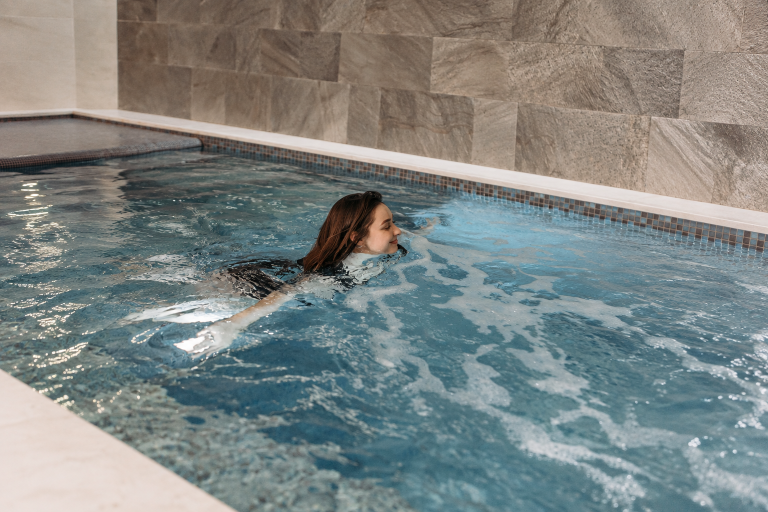 Woman swimming in an indoor swim spa